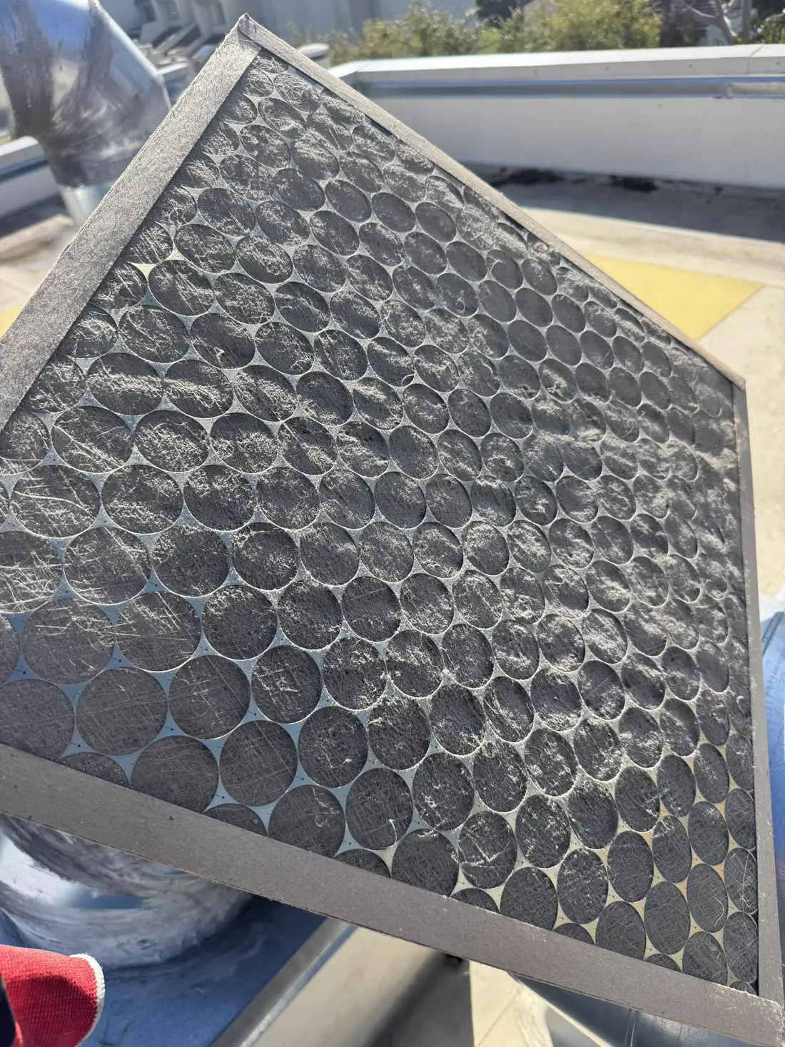 Dirty air filter from a Pasadena, CA home, caked in a solid layer of gray dust
